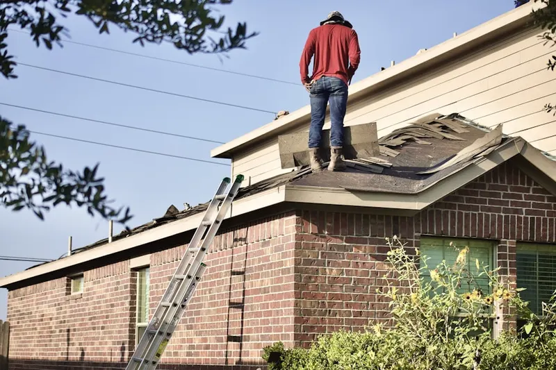 Professional roofer working on a residential roof in North Takoma Park